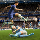 Two FIFA players are going at it on the soccer field, with one attempting to slide tackle the other and totally missing.